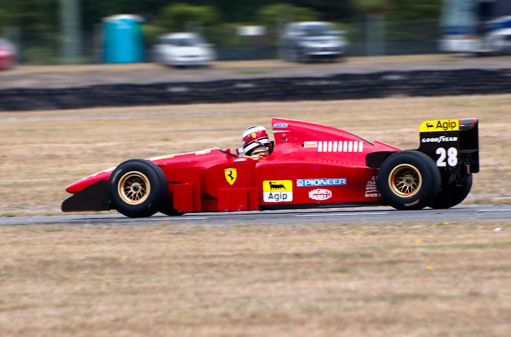 Formula 1 racing car at speed on circuit track during grand prix