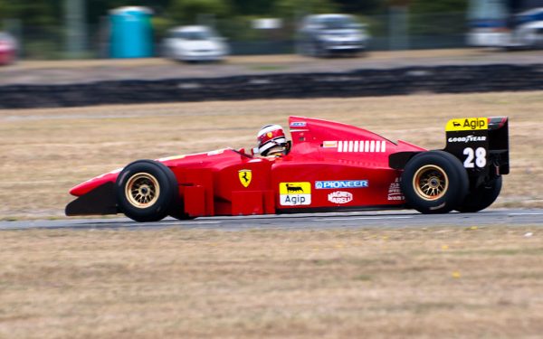 Formula 1 racing car at speed on circuit track during grand prix