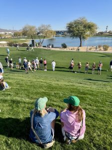 Golf course green fairway during major tournament with spectators watching