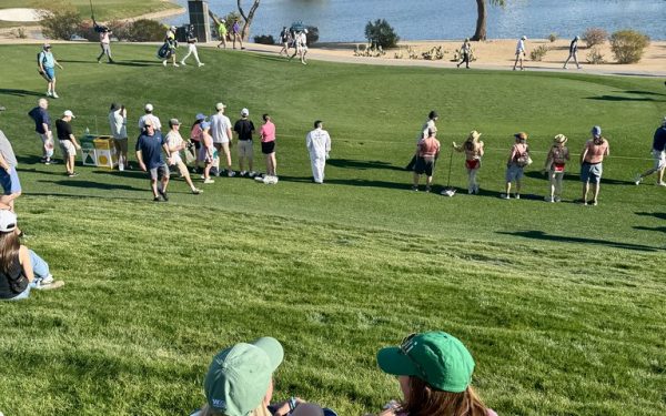 Golf course green fairway during major tournament with spectators watching