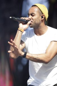 Large sports arena with stage lighting and packed crowd for major event