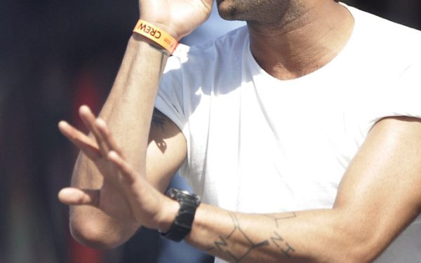 Large sports arena with stage lighting and packed crowd for major event